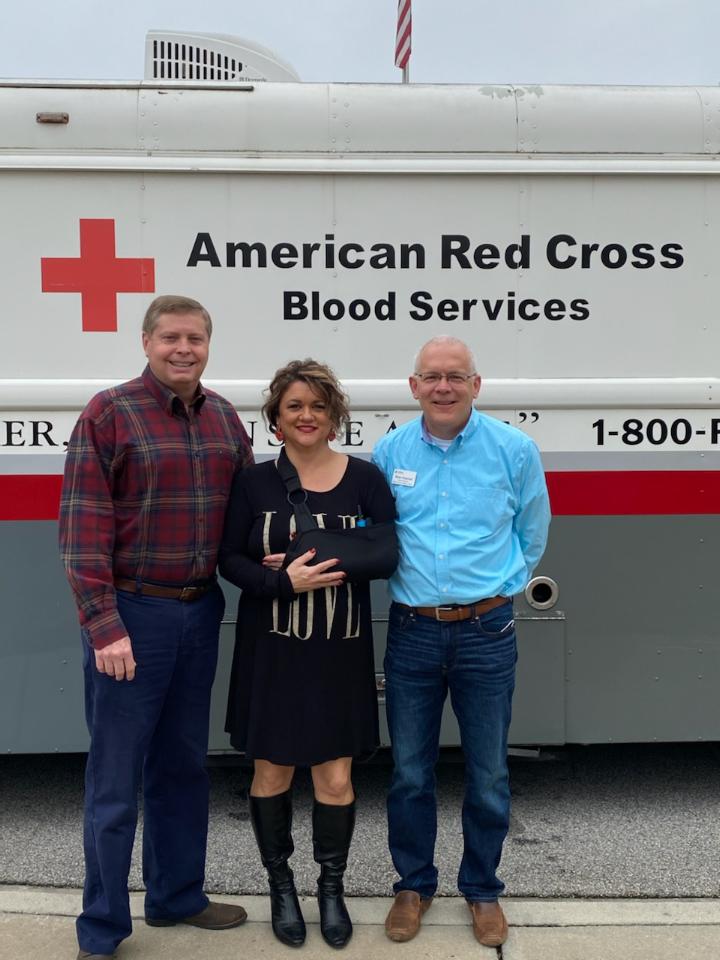 Employees standing in front of the American Red Cross Bloodmobile